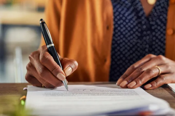 una persona firmaun contratto