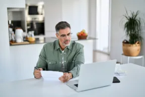 una persona controlla un documento mentre è al computer
