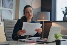 una persona legge dei documenti in ufficio