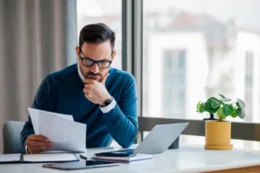 una persona concentrata legge dei documenti